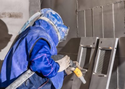 man inspecting his sandblasting cape town